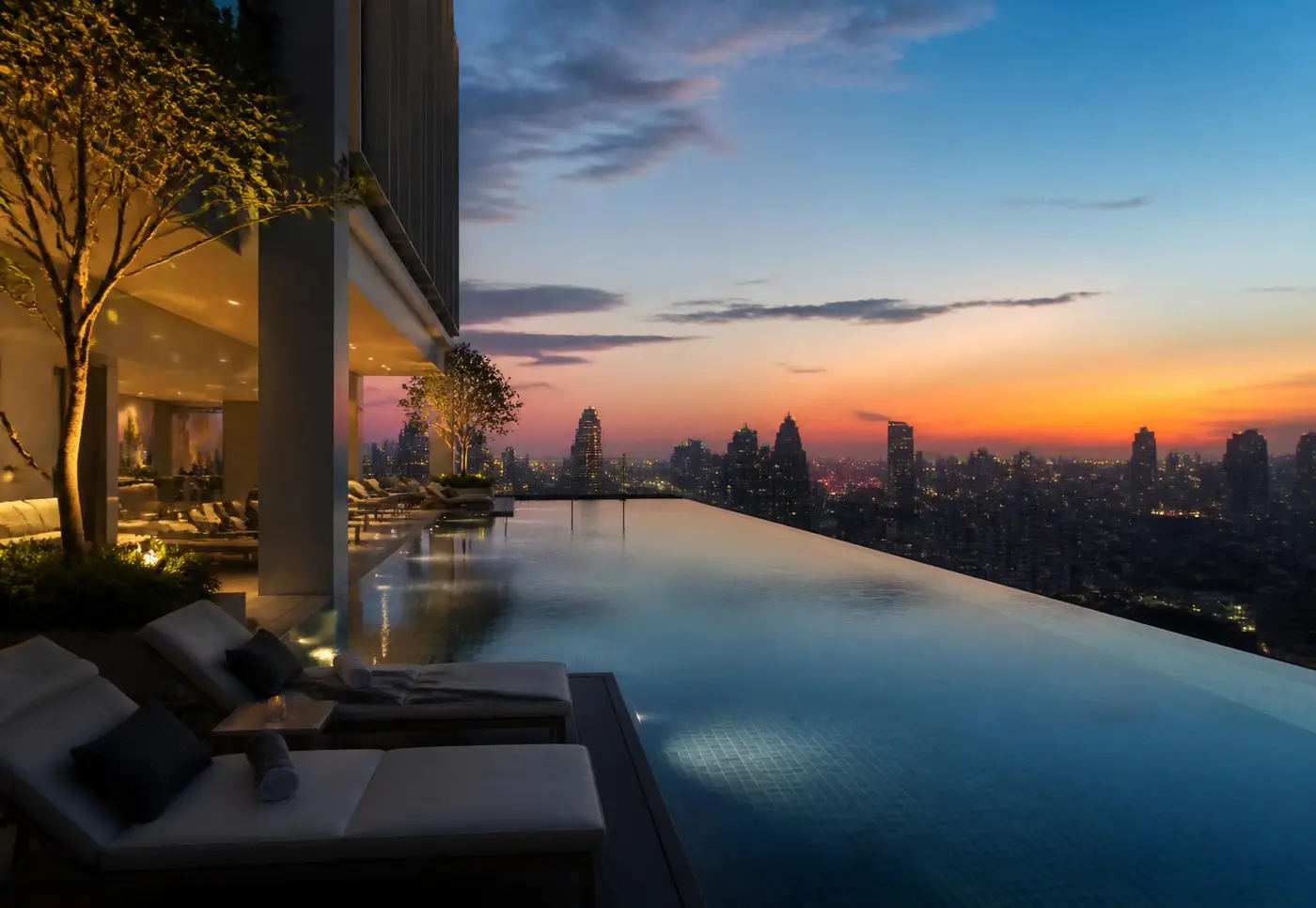 Rooftop infinity pool at dusk overlooking city skyline